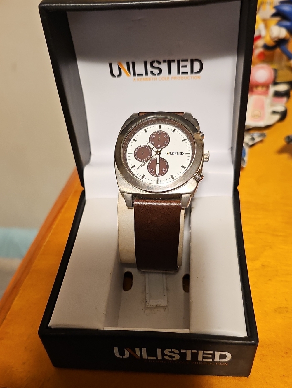 Unlisted by Kenneth Cole Silver Case Watch with Brown Leather Strap
